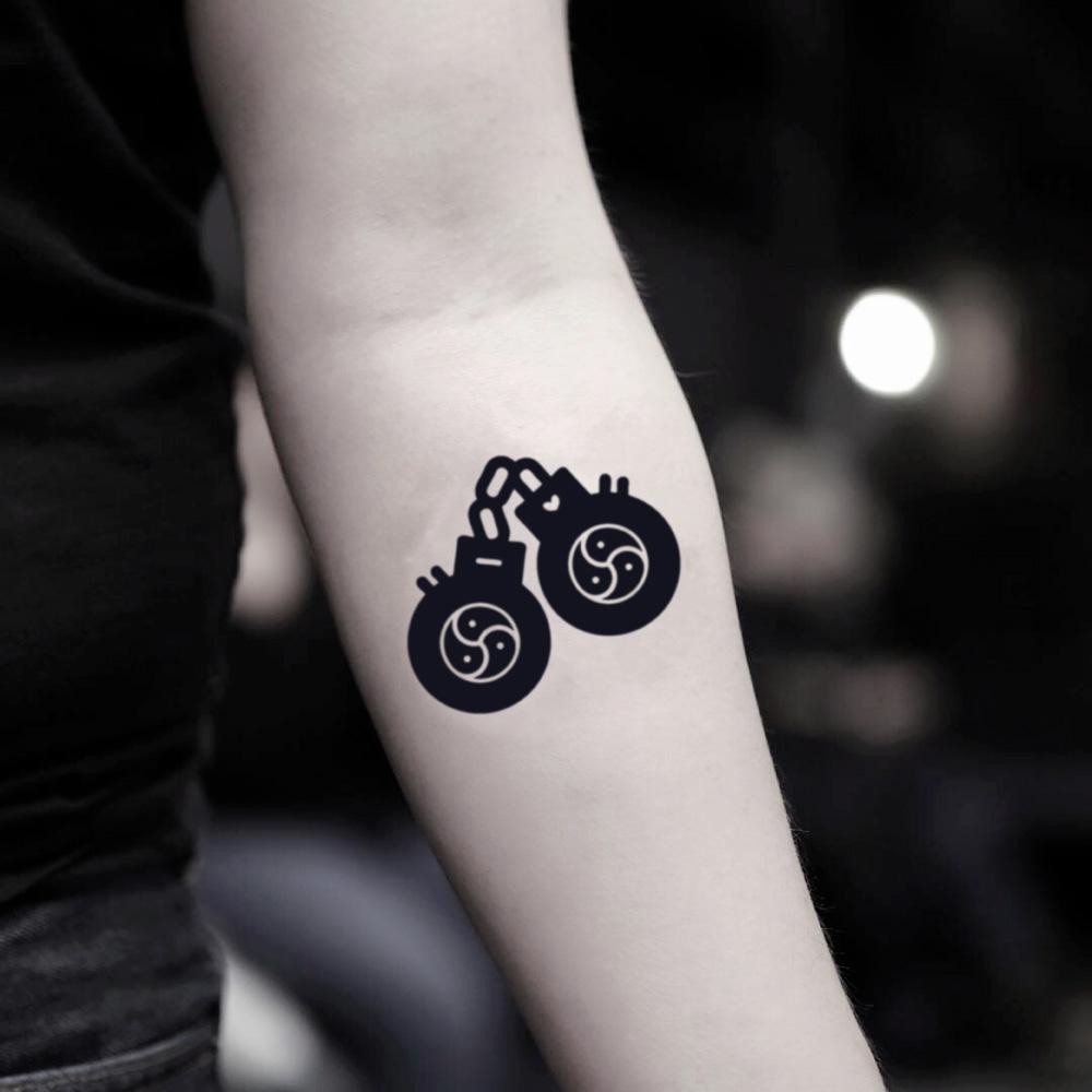 fake small bdsm handcuffs illustrative temporary tattoo sticker design idea on inner arm