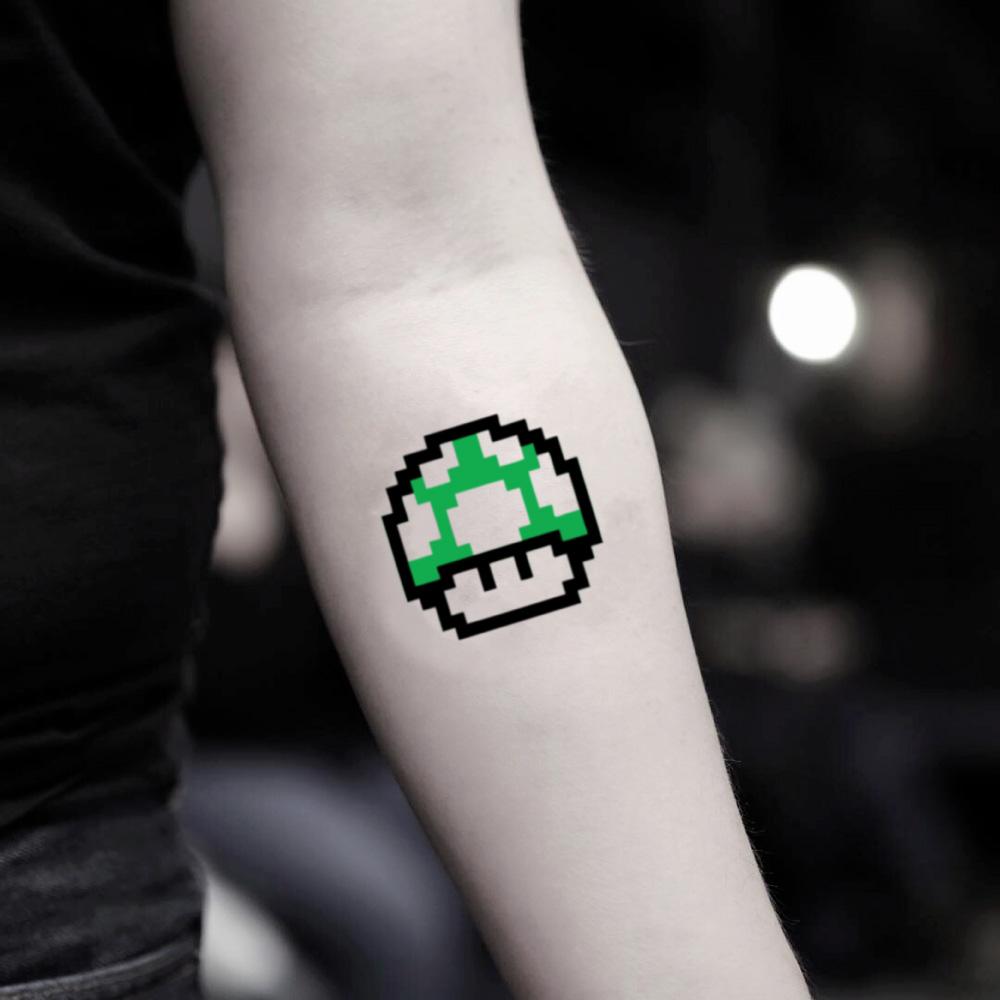 fake small nintendo super mario kart mushroom color temporary tattoo sticker design idea on inner arm