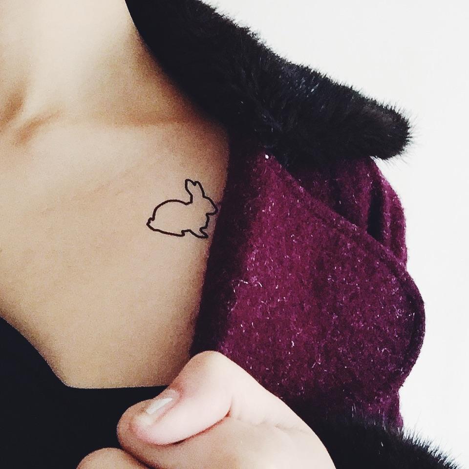 fake small black rabbit outline watership down animal temporary tattoo sticker design idea on chest