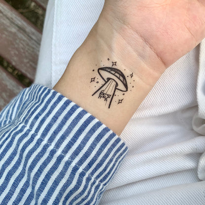 fake small alien spaceship abduction ufo dainty illustrative temporary tattoo sticker design idea on wrist
