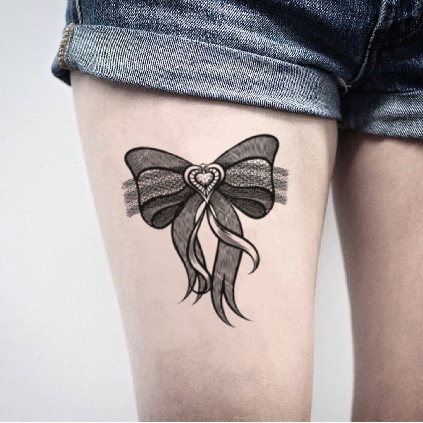 fake big garter bow on legs vintage temporary tattoo sticker design idea on thigh
