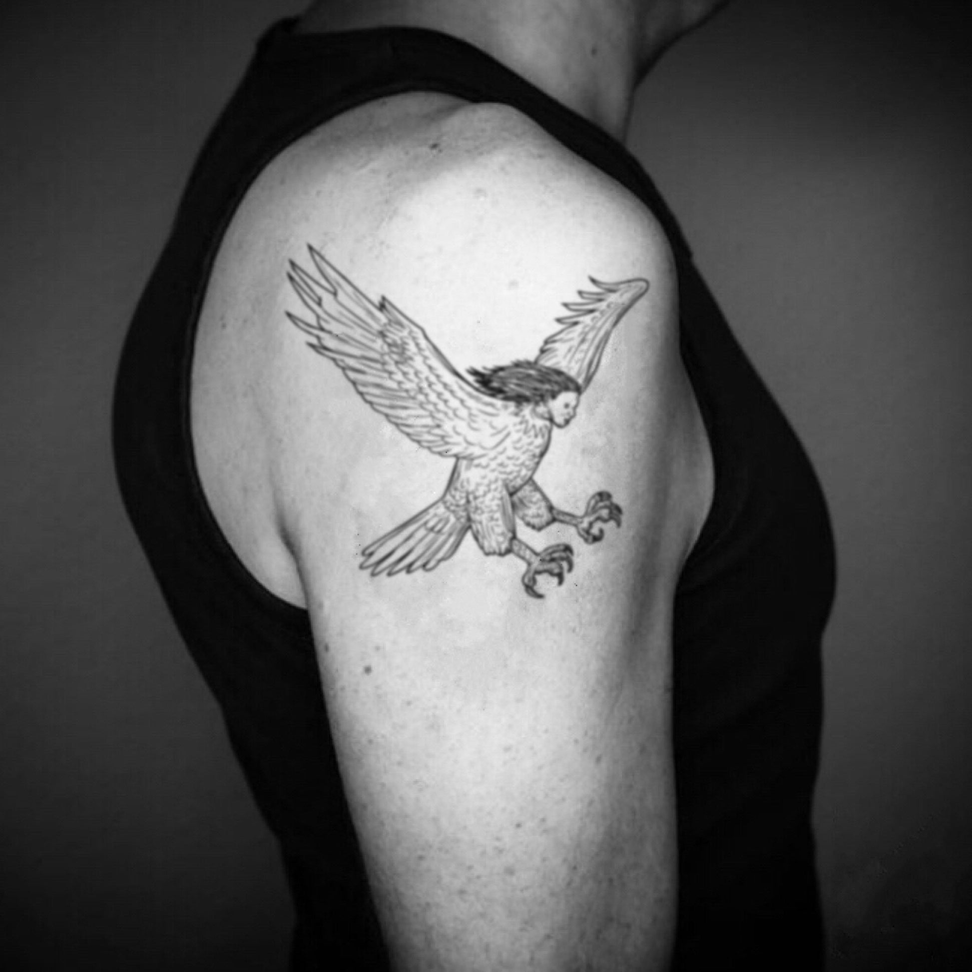 fake big harpy eagle illustrative temporary tattoo sticker design idea on upper arm