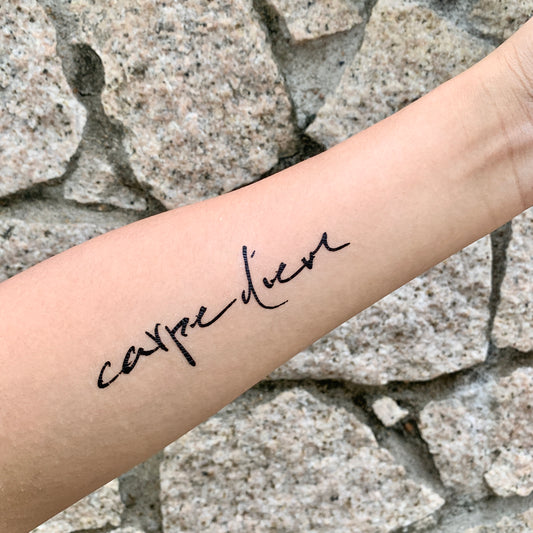 fake small carpe diem seize the day lettering temporary tattoo sticker design idea on forearm