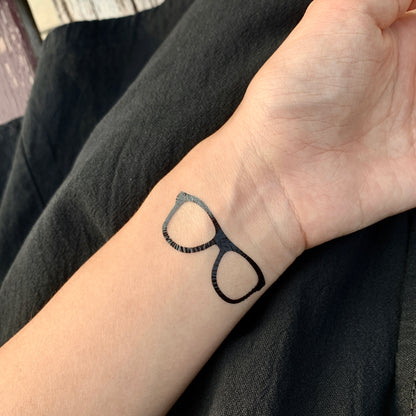 fake small eyeglasses glasses minimalist temporary tattoo sticker design idea on wrist