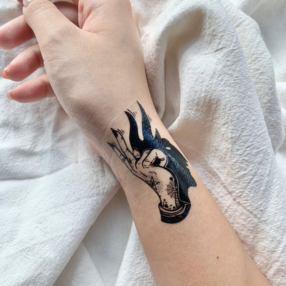 fake small magic idle hand shadow illustrative temporary tattoo sticker design idea on wrist
