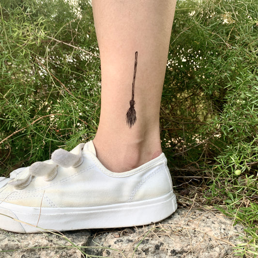 fake small witch broom simple halloween witchy wiccan witchcraft minimalist temporary tattoo sticker design idea on leg ankle
