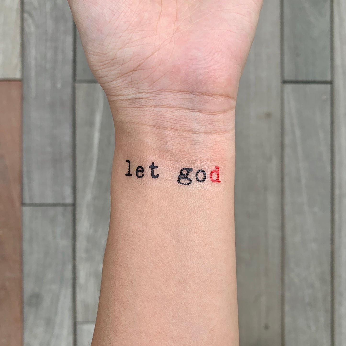 fake small let go let god lettering temporary tattoo sticker design idea on wrist