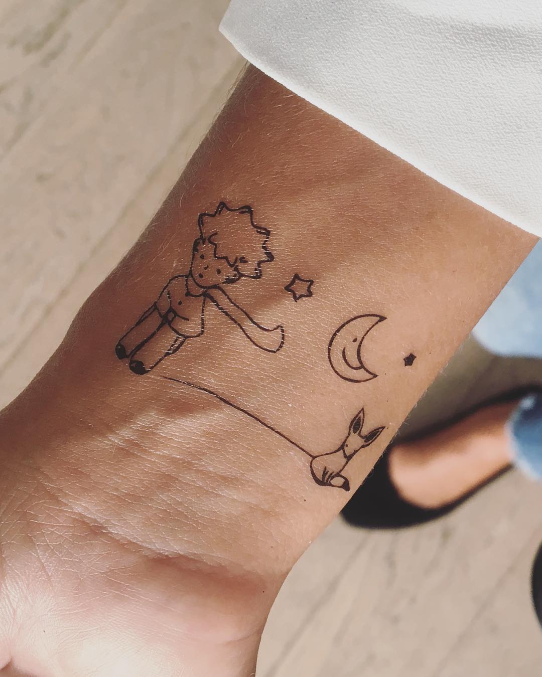 fake small little prince illustrative temporary tattoo sticker design idea on wrist
