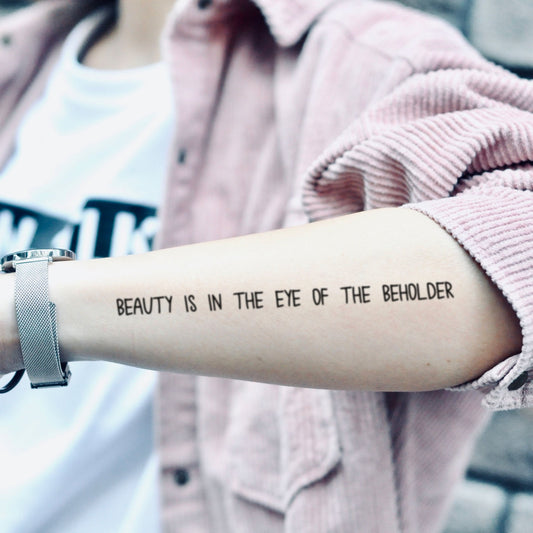 fake medium beauty is in the eye of the beholder lettering temporary tattoo sticker design idea on forearm