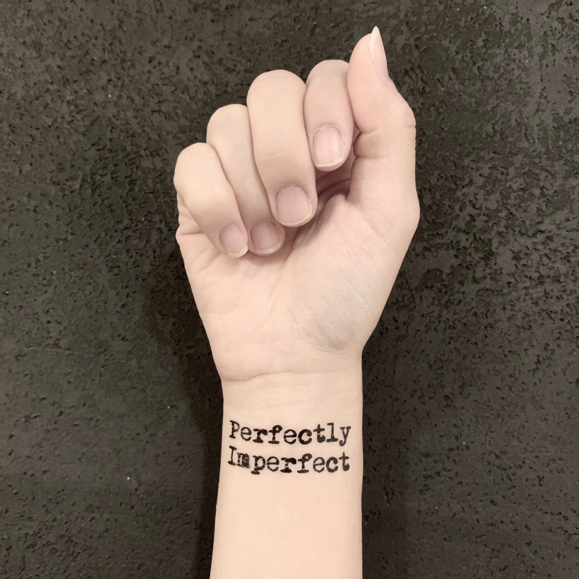 fake small perfectly imperfect lettering temporary tattoo sticker design idea on wrist