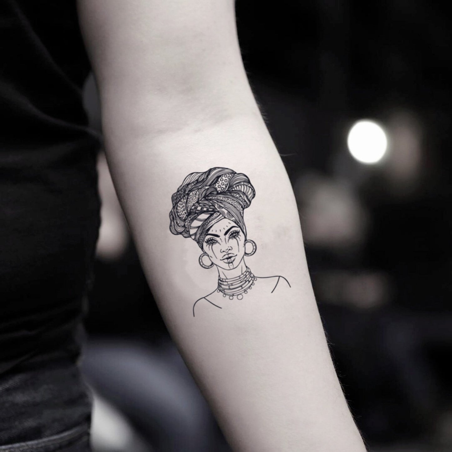 fake small black african woman illustrative temporary tattoo sticker design idea on inner arm