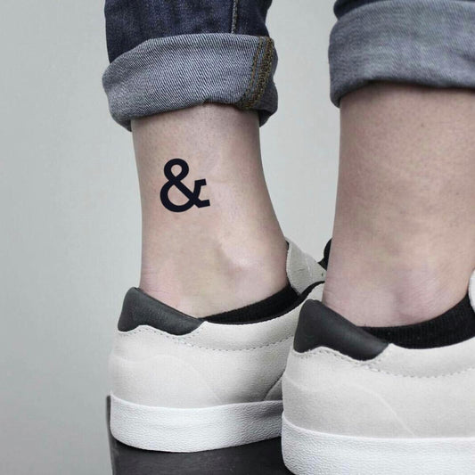 fake small ampersand & of mice and men minimalist temporary tattoo sticker design idea on ankle
