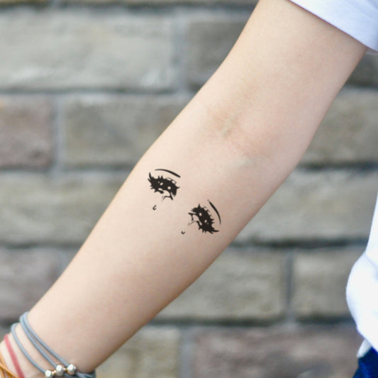 fake small anime eyes illustrative temporary tattoo sticker design idea on inner arm