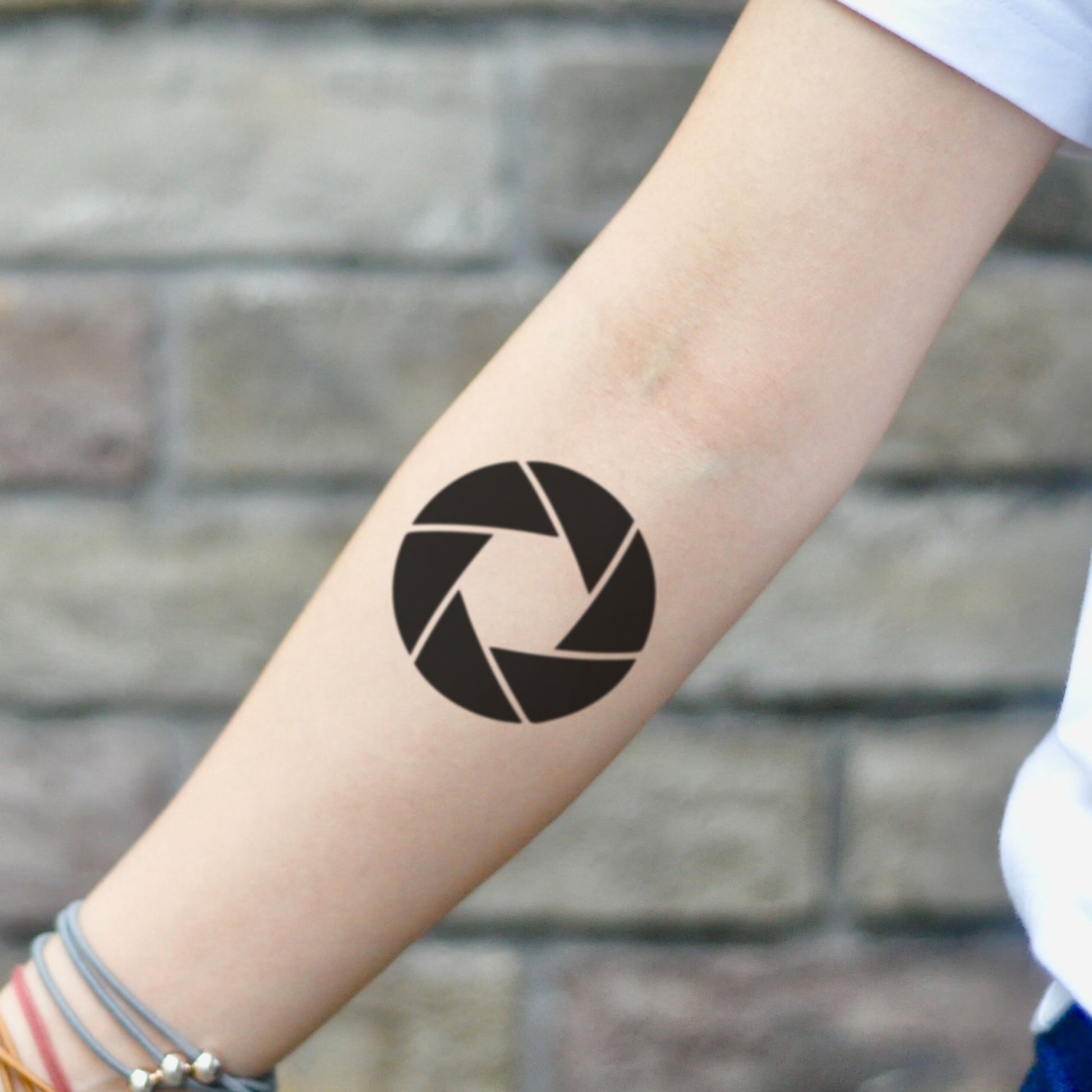 fake small aperture geometric temporary tattoo sticker design idea on inner arm
