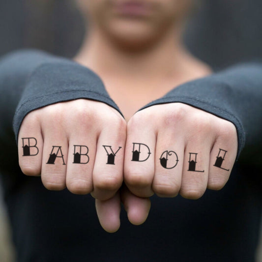 fake small babydoll lettering temporary tattoo sticker design idea on finger