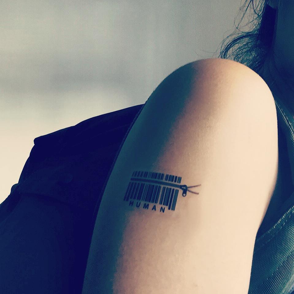 fake small barcode scan hitman mankind human sex slave trafficking minimalist temporary tattoo sticker design idea on upper arm