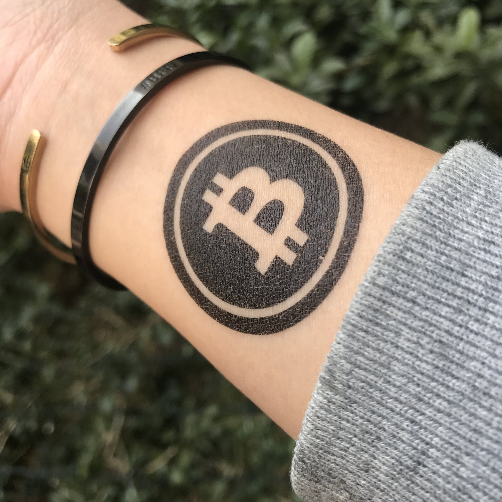 fake small bitcoin dollar sign minimalist temporary tattoo sticker design idea on wrist