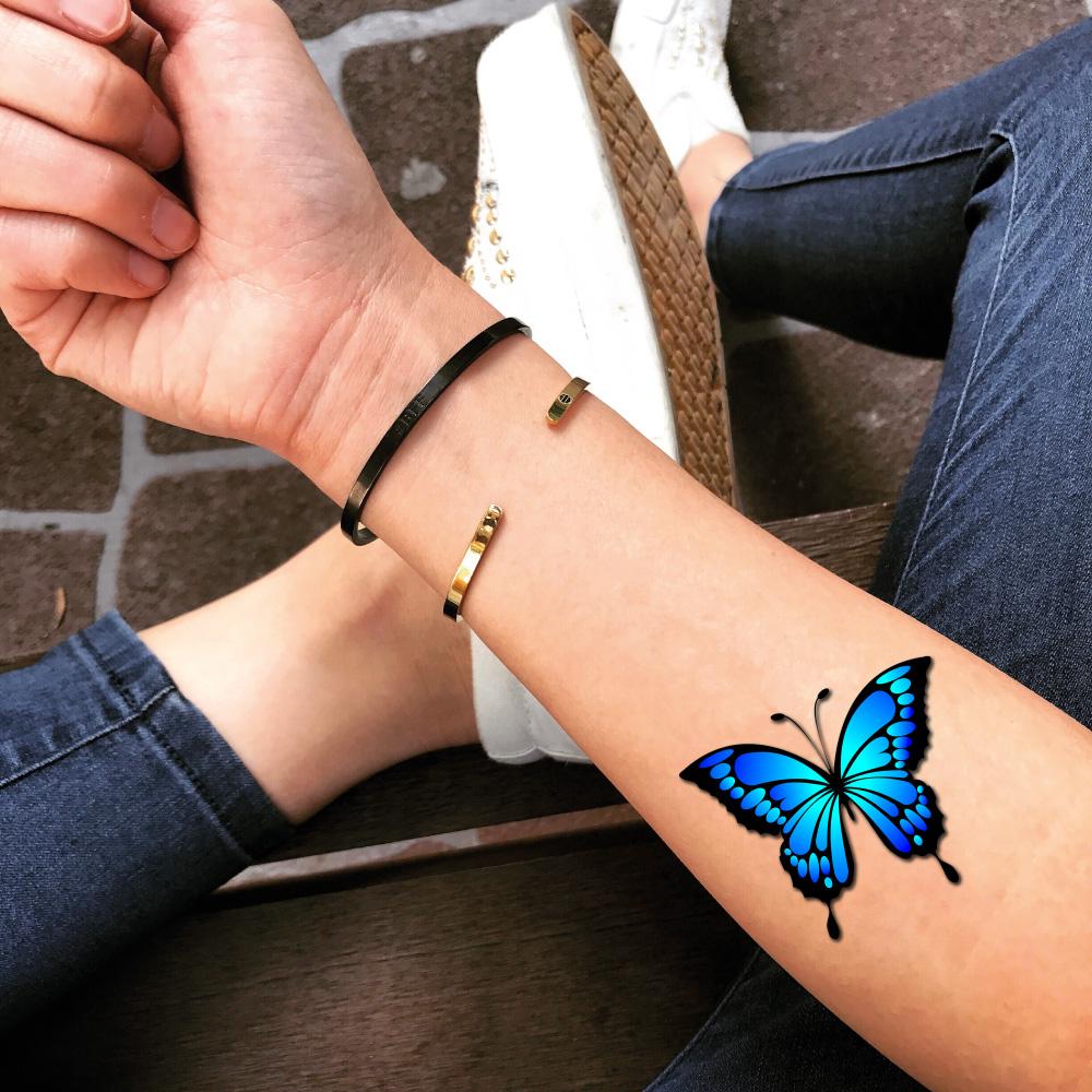 fake small light true blue morpho mariposa butterfly color photo realism style animal temporary tattoo sticker design idea on forearm