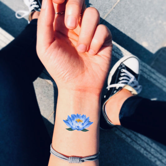 fake small blue lotus flower temporary tattoo sticker design idea on wrist