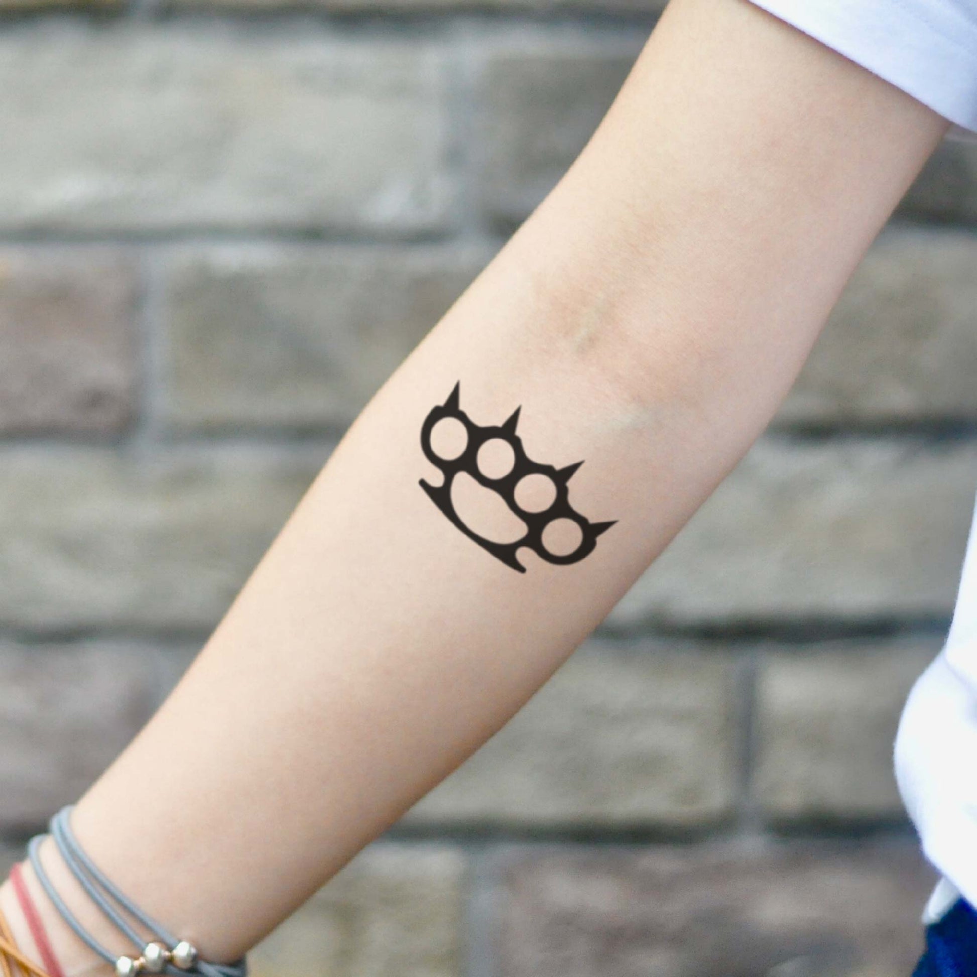fake small simple spiked brass knuckles old school gangster black minimalist temporary tattoo sticker design idea on inner arm forearm