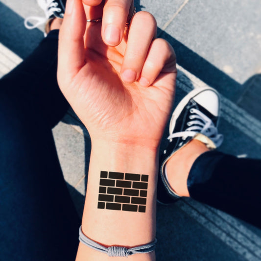 fake small brick wall pink floyd geometric temporary tattoo sticker design idea on wrist