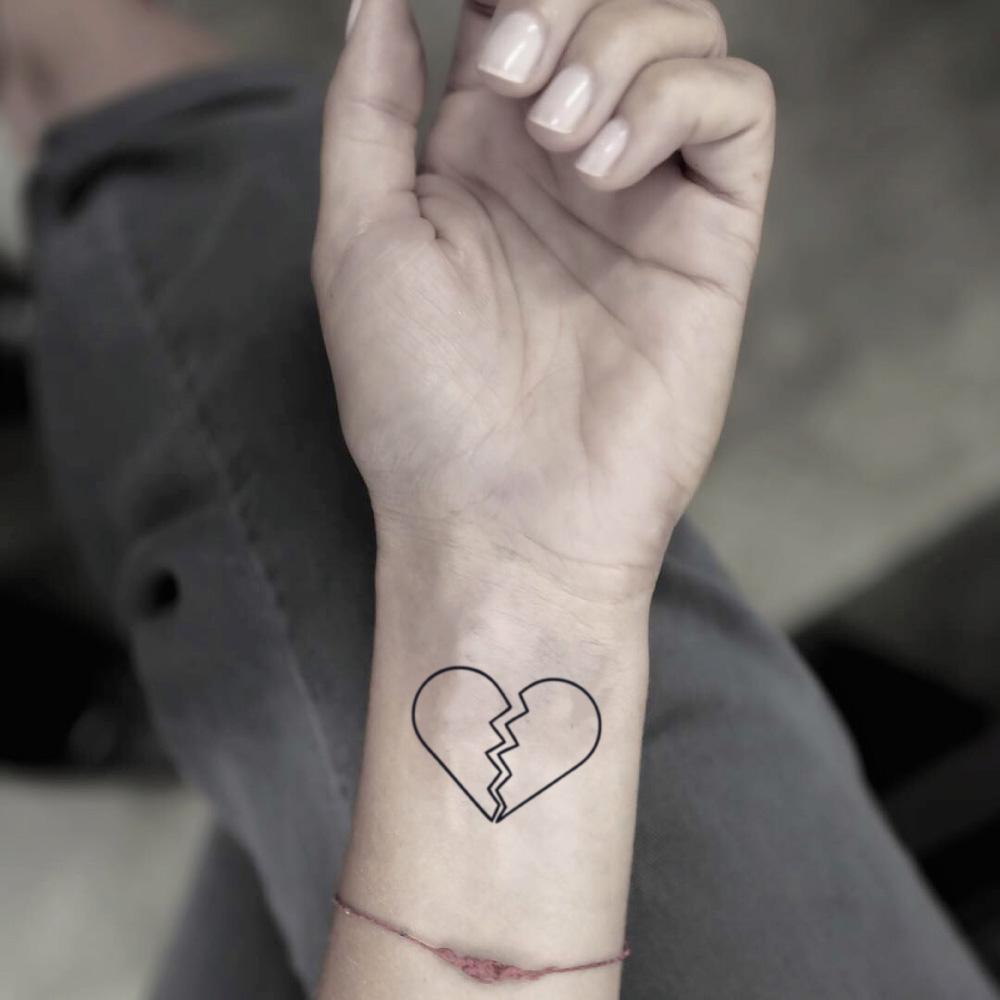 fake small broken half shattered heart simple outline minimalist temporary tattoo sticker design idea on wrist