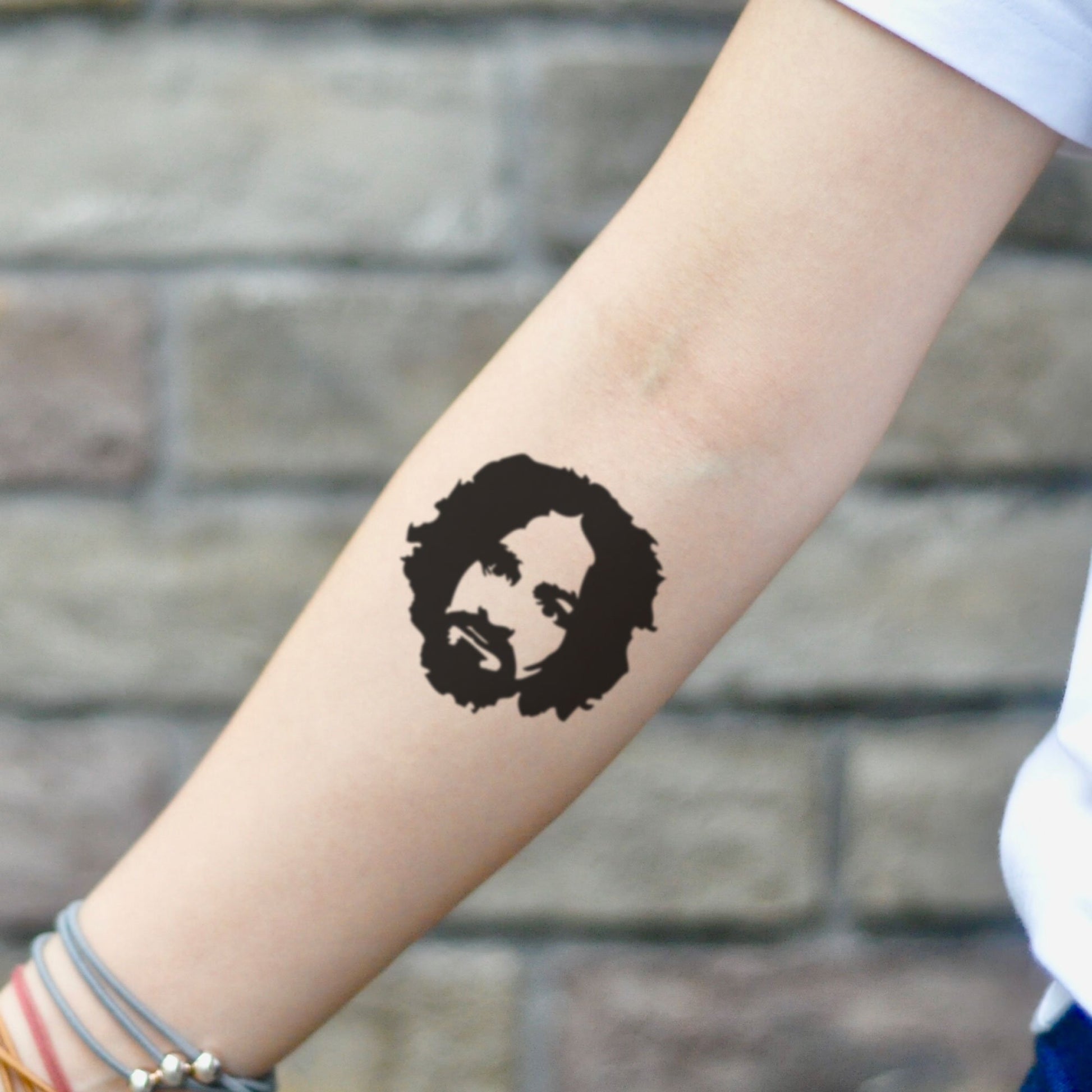 fake small charles manson portrait temporary tattoo sticker design idea on inner arm