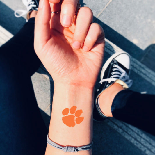 fake small clemson paw color temporary tattoo sticker design idea on wrist