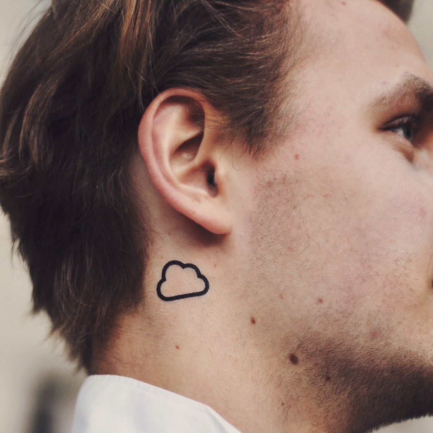 fake small black cloud outline nature minimalist temporary tattoo sticker design idea on neck