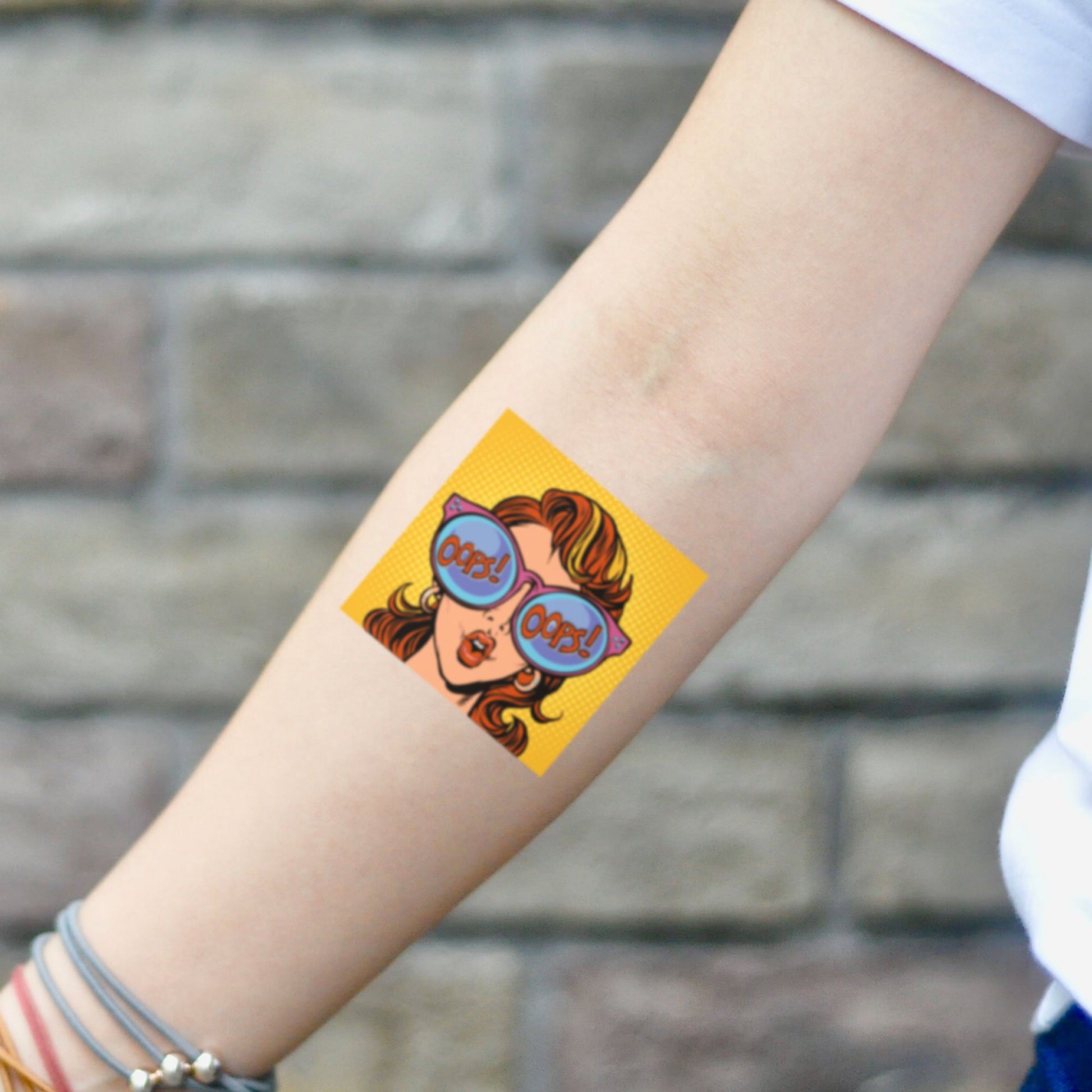 fake small comic book pop art color temporary tattoo sticker design idea on inner arm