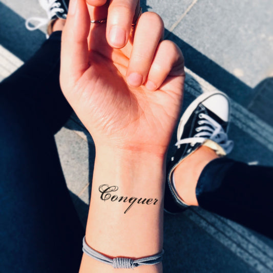 fake small conquer Lettering temporary tattoo sticker design idea on wrist