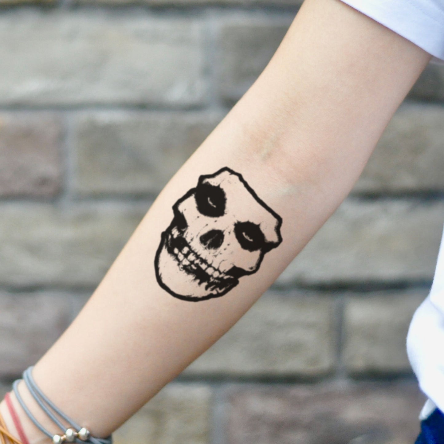 fake small crimson ghost Illustrative temporary tattoo sticker design idea on inner arm