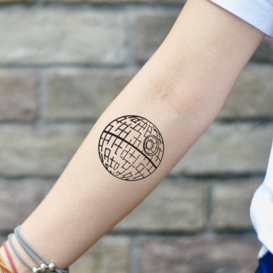fake small death star Minimalist temporary tattoo sticker design idea on inner arm