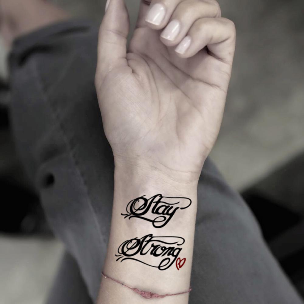 fake small demi lovato stay strong lettering temporary tattoo sticker design idea on wrist