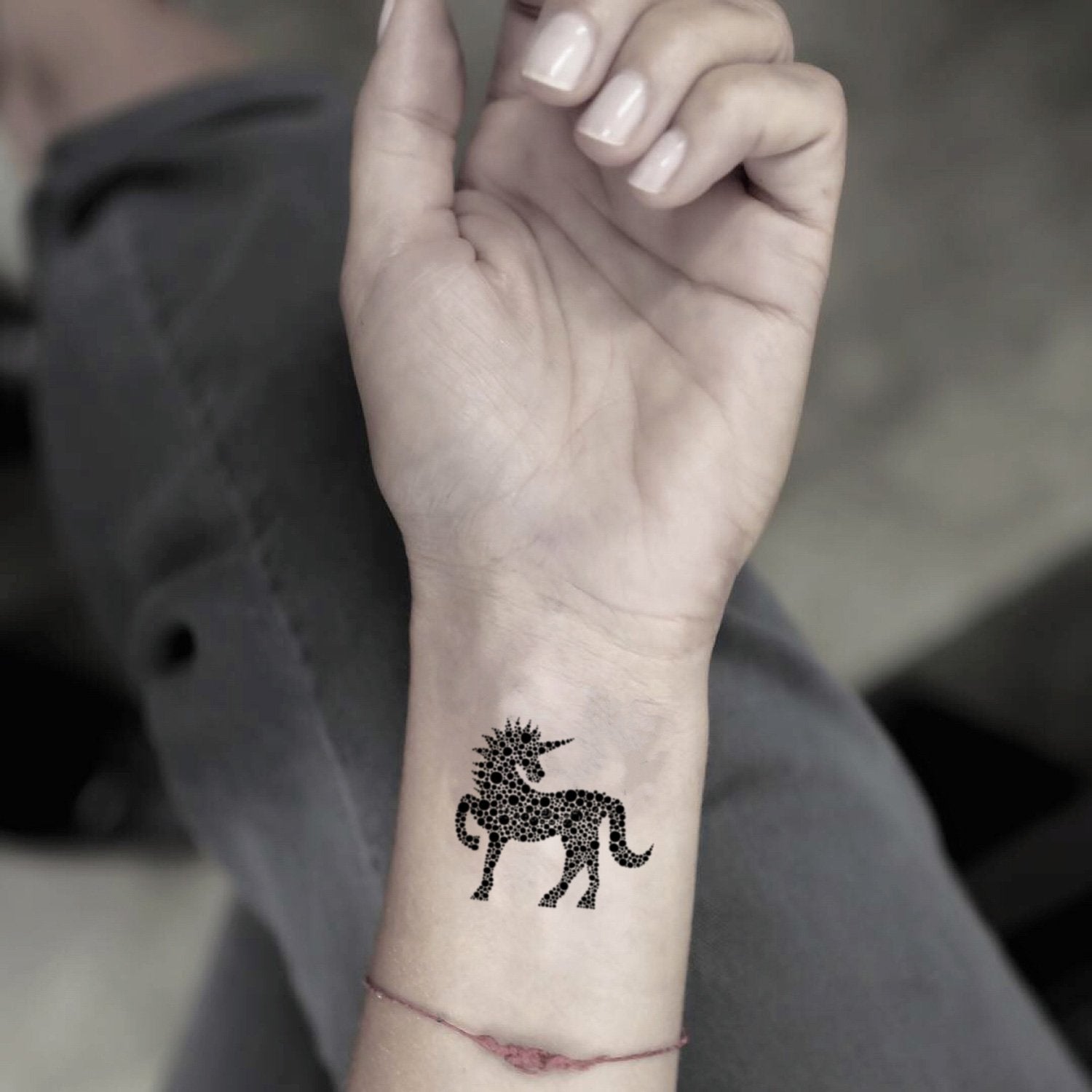 fake small dotted unicorn animal temporary tattoo sticker design idea on wrist