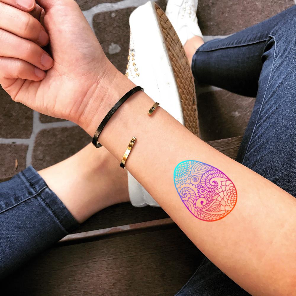 fake small easter egg color temporary tattoo sticker design idea on forearm