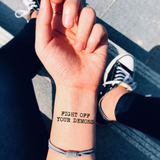 fake small fight off your demons lettering temporary tattoo sticker design idea on wrist
