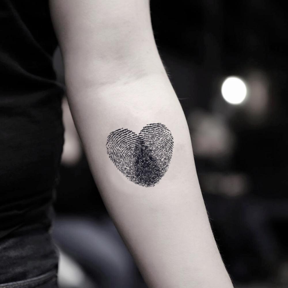 fake small heart shape fingerprint illustrative temporary tattoo sticker design idea on inner arm