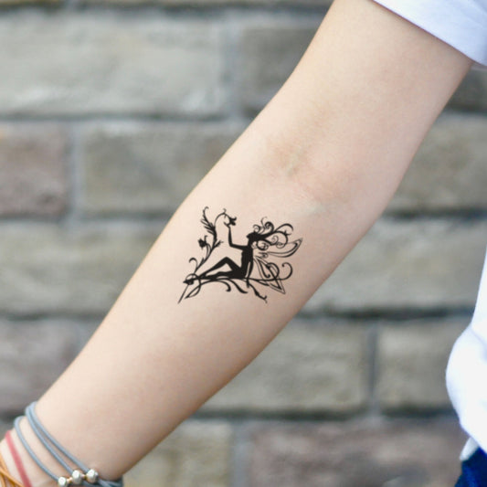 fake small flower fairy illustrative temporary tattoo sticker design idea on inner arm