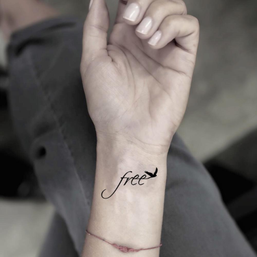 fake small free word with bird lettering temporary tattoo sticker design idea on wrist