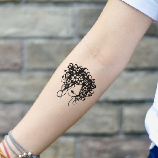 fake small furry flower head illustrative temporary tattoo sticker design idea on inner arm