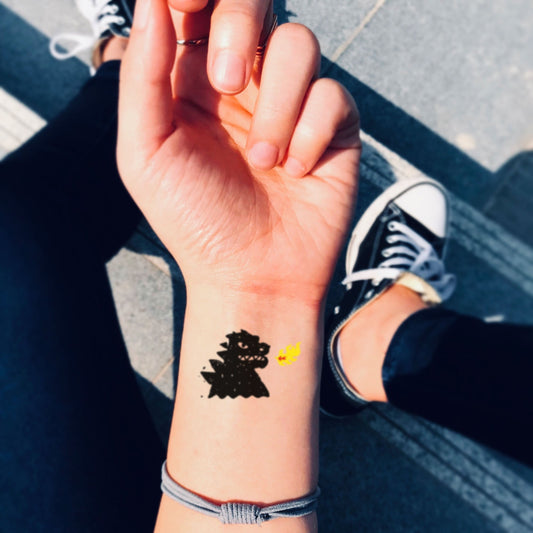 fake small godzilla kaiju minimalist temporary tattoo sticker design idea on wrist