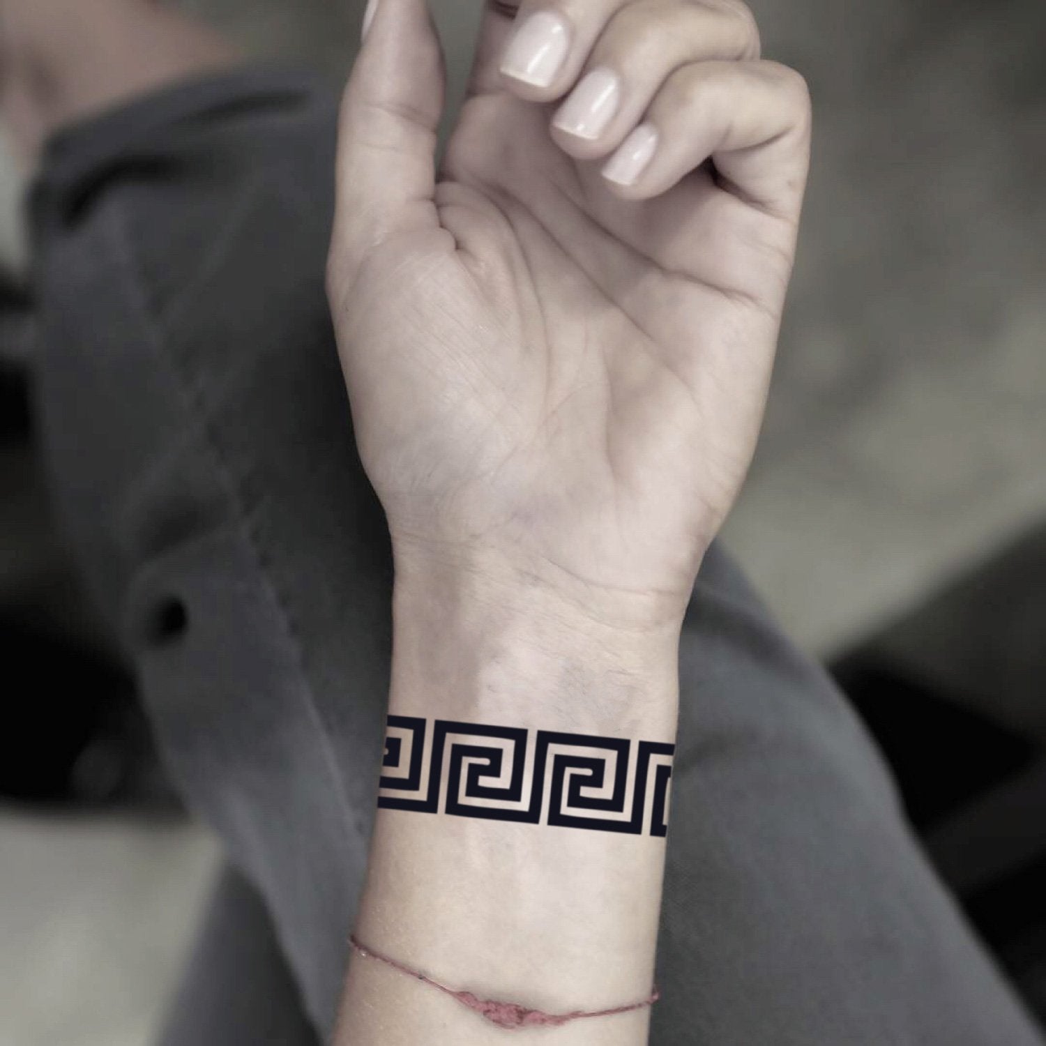 fake small greek key geometric temporary tattoo sticker design idea on wrist