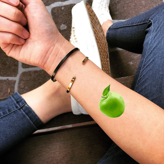 fake small green apple food color temporary tattoo sticker design idea on forearm