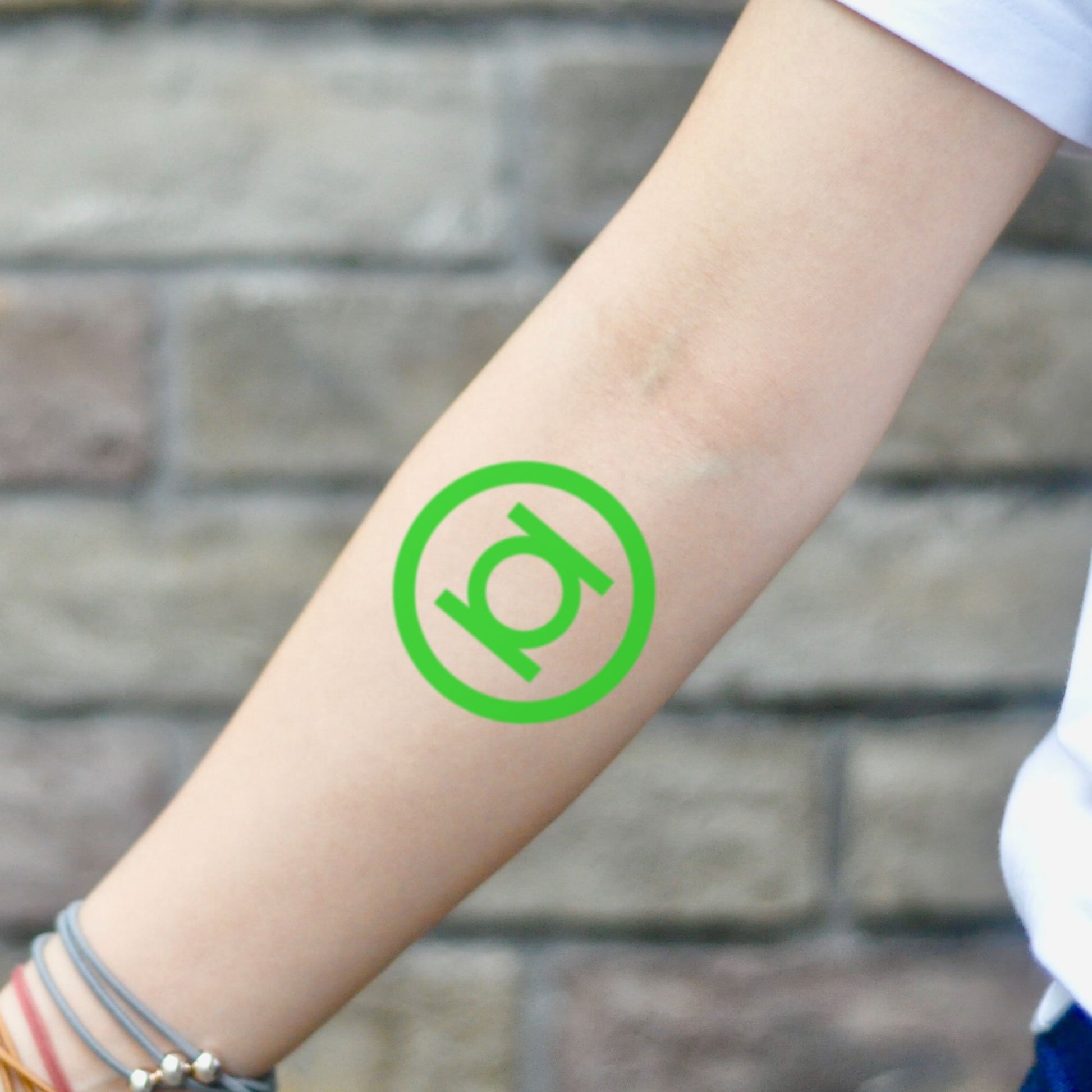 fake small green lantern color temporary tattoo sticker design idea on inner arm