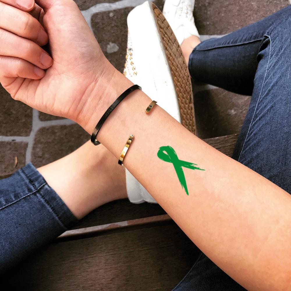 fake small green ribbon lymphoma color temporary tattoo sticker design idea on forearm