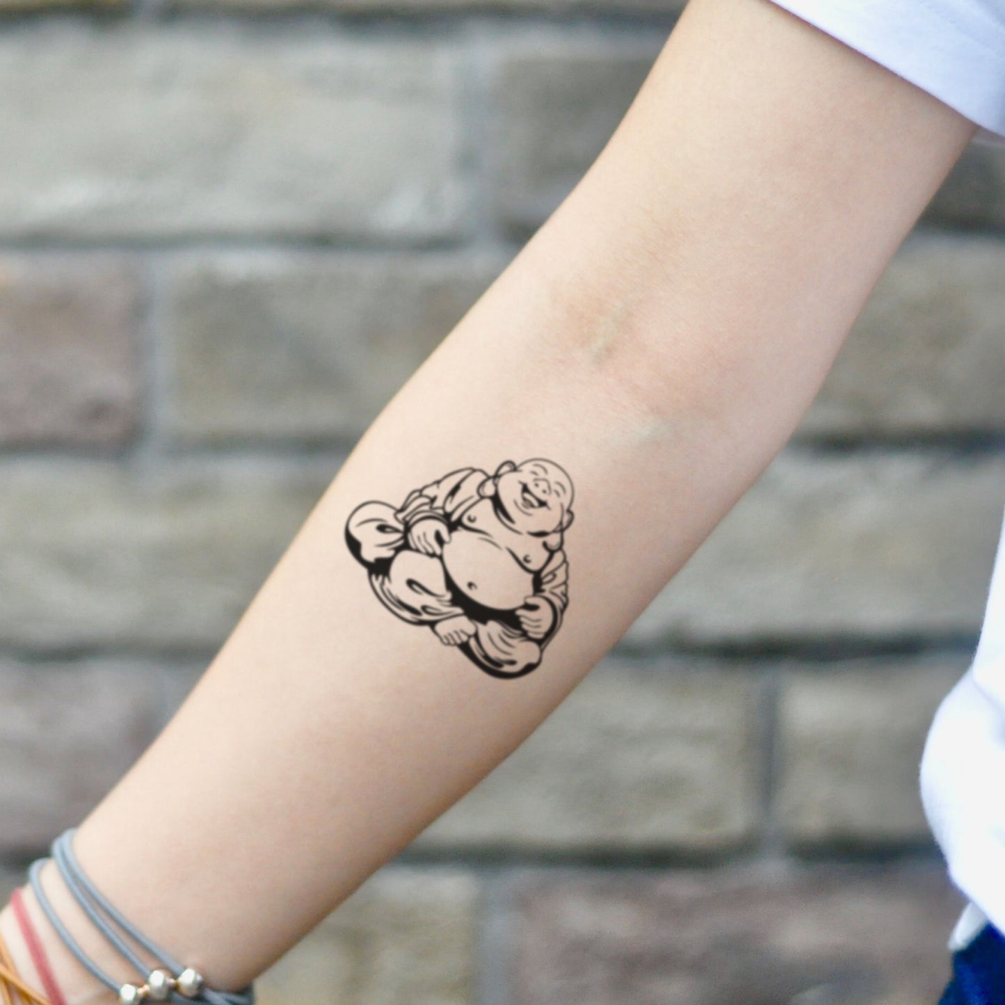 fake small happy laughing fat buddha illustrative temporary tattoo sticker design idea on inner arm