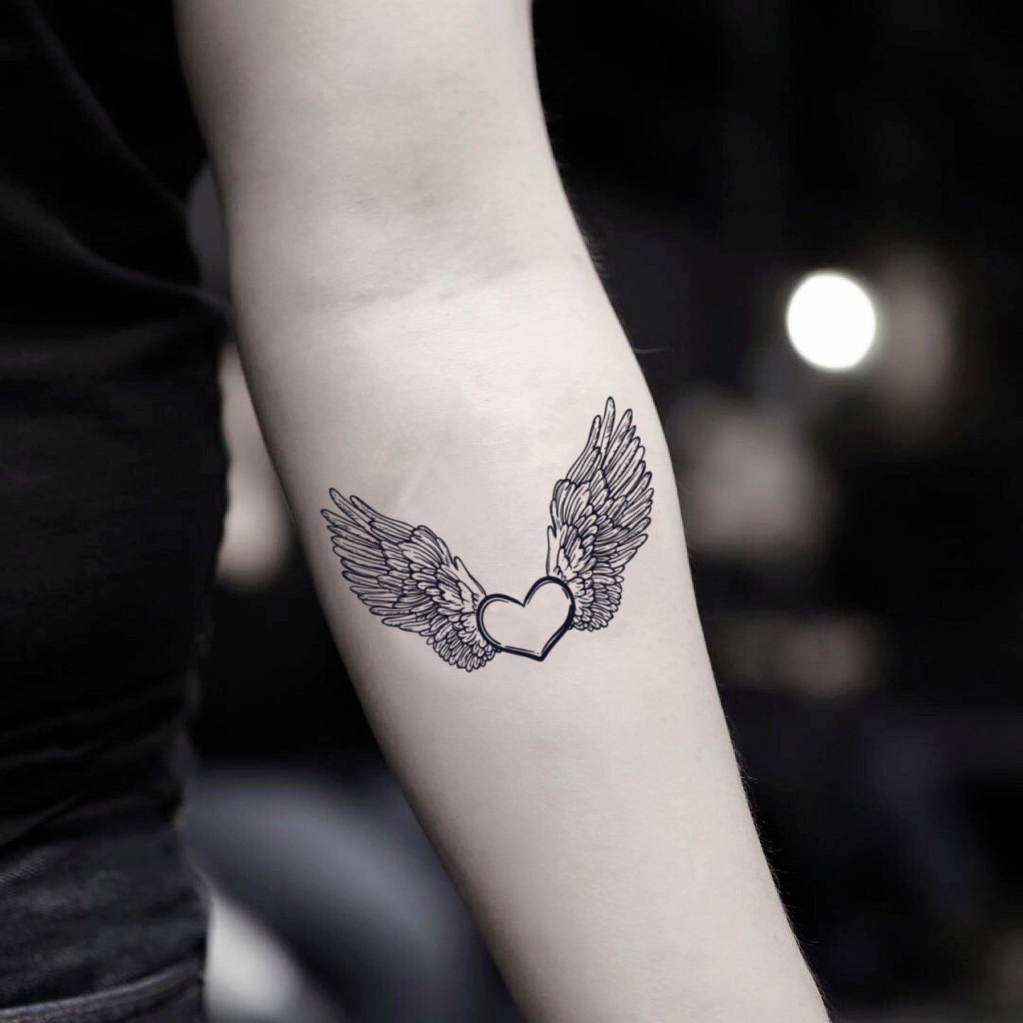 fake small heart with angel wings illustrative temporary tattoo sticker design idea on inner arm