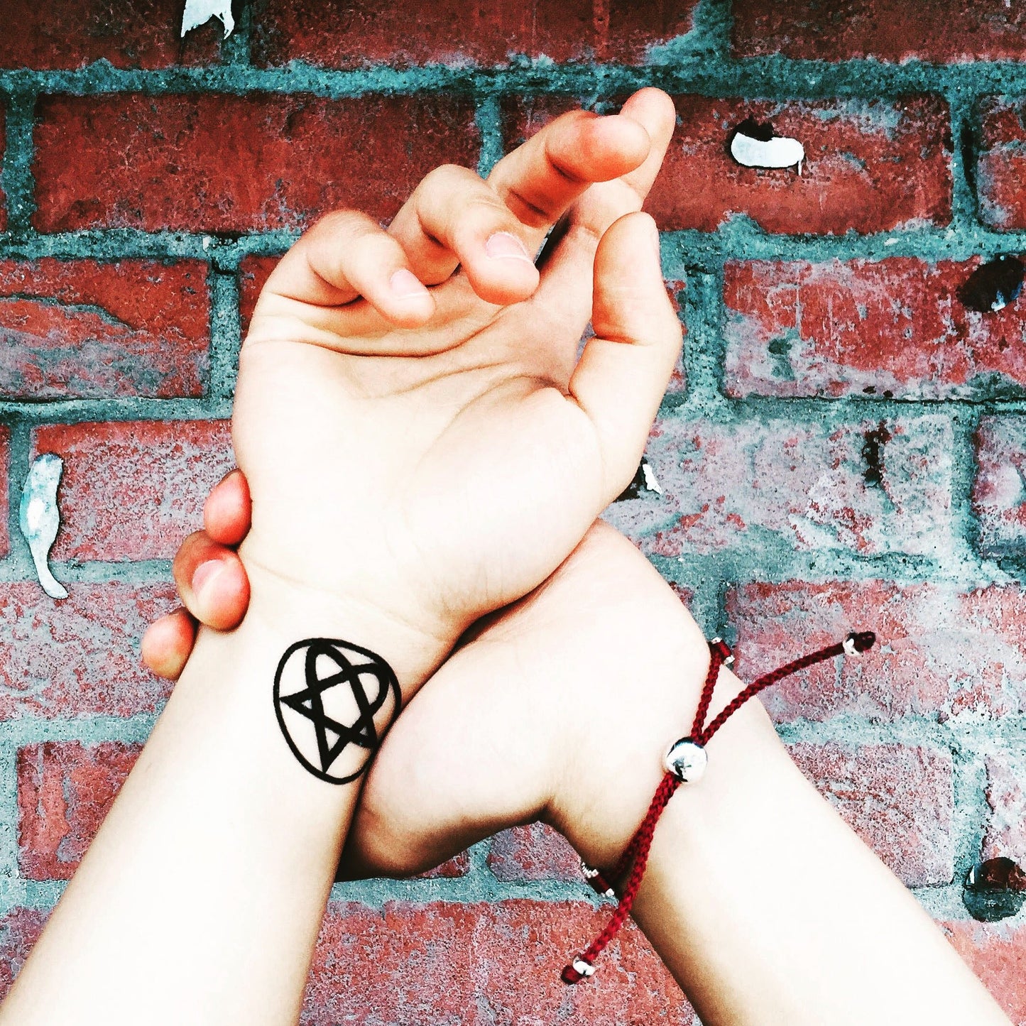 fake small heartagram him logo minimalist temporary tattoo sticker design idea on wrist