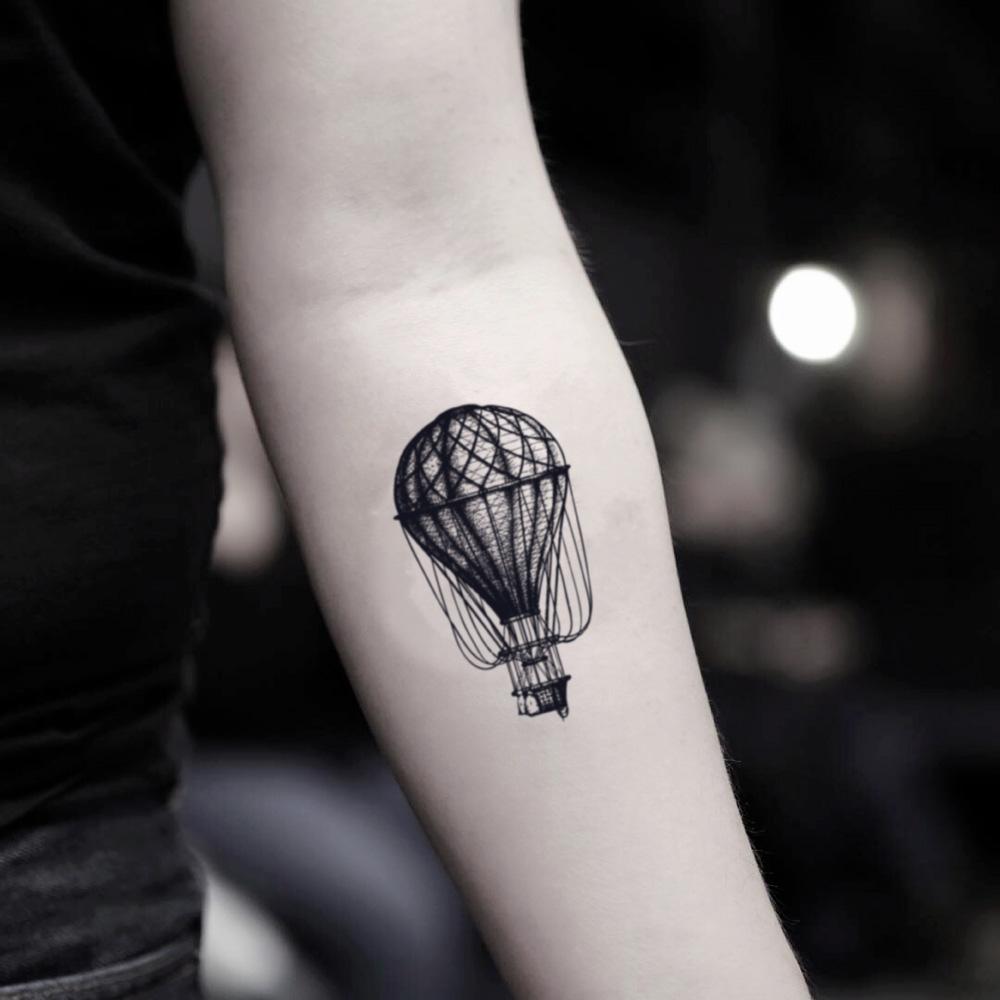 fake small hot air balloon illustrative temporary tattoo sticker design idea on inner arm